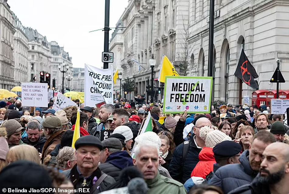 Protestors seen holding placards that say medical freedom during a demonstration against vaccine mandates in the UK,
