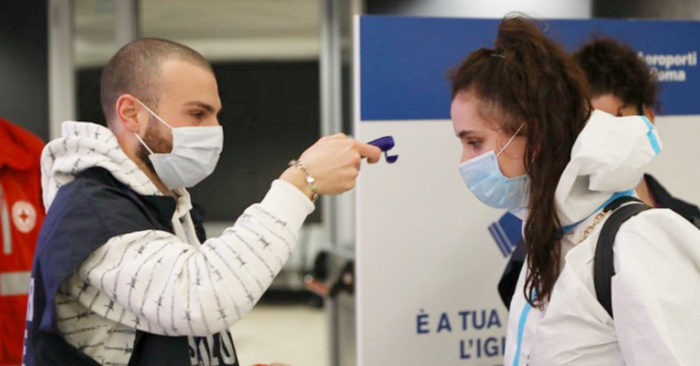 Taking the temperature of a person at Fiumicino airport, Italy, April 20, 2020