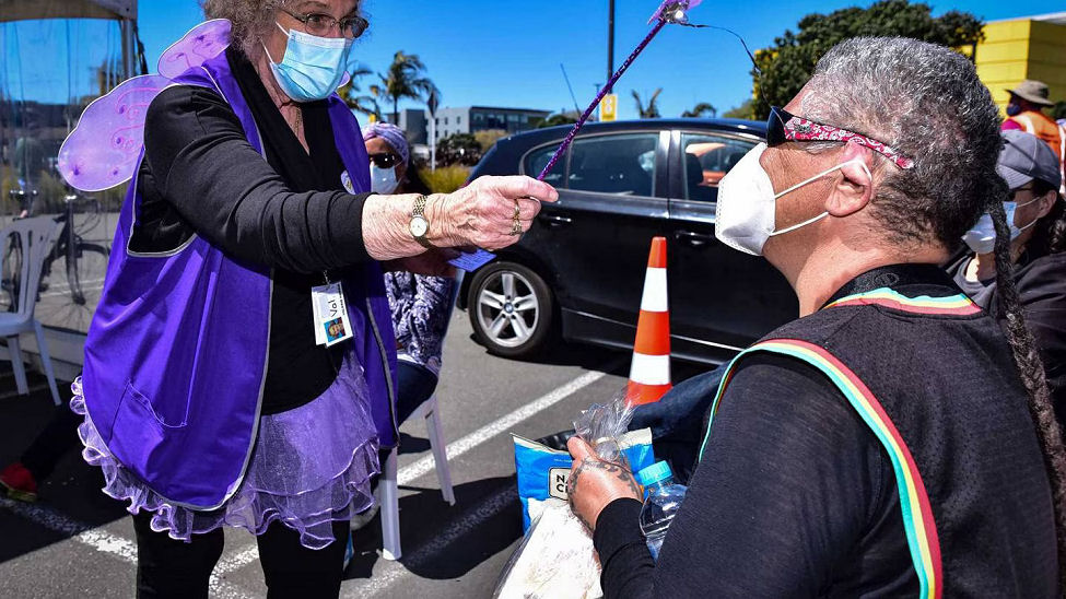 The Fairy God nurse Valerie Harris blesses Lovey Gillies of Napier at a vaccination clinic on Super Saturday.