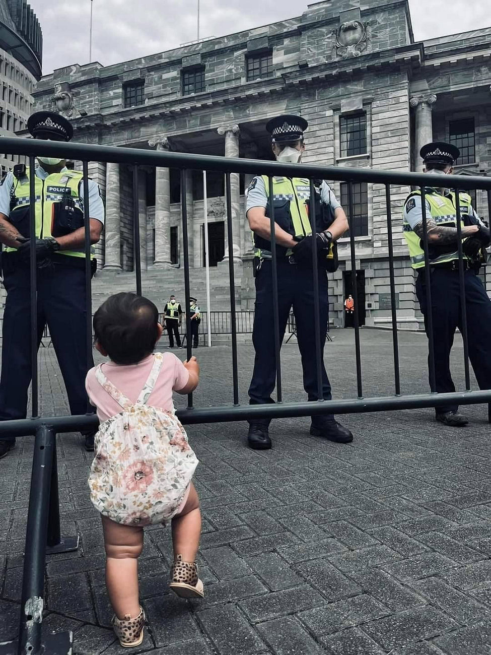 WELLINGTON UPDATE - Brutish Police / thugs at New Zealand Parliament look at innocent child through the barrier